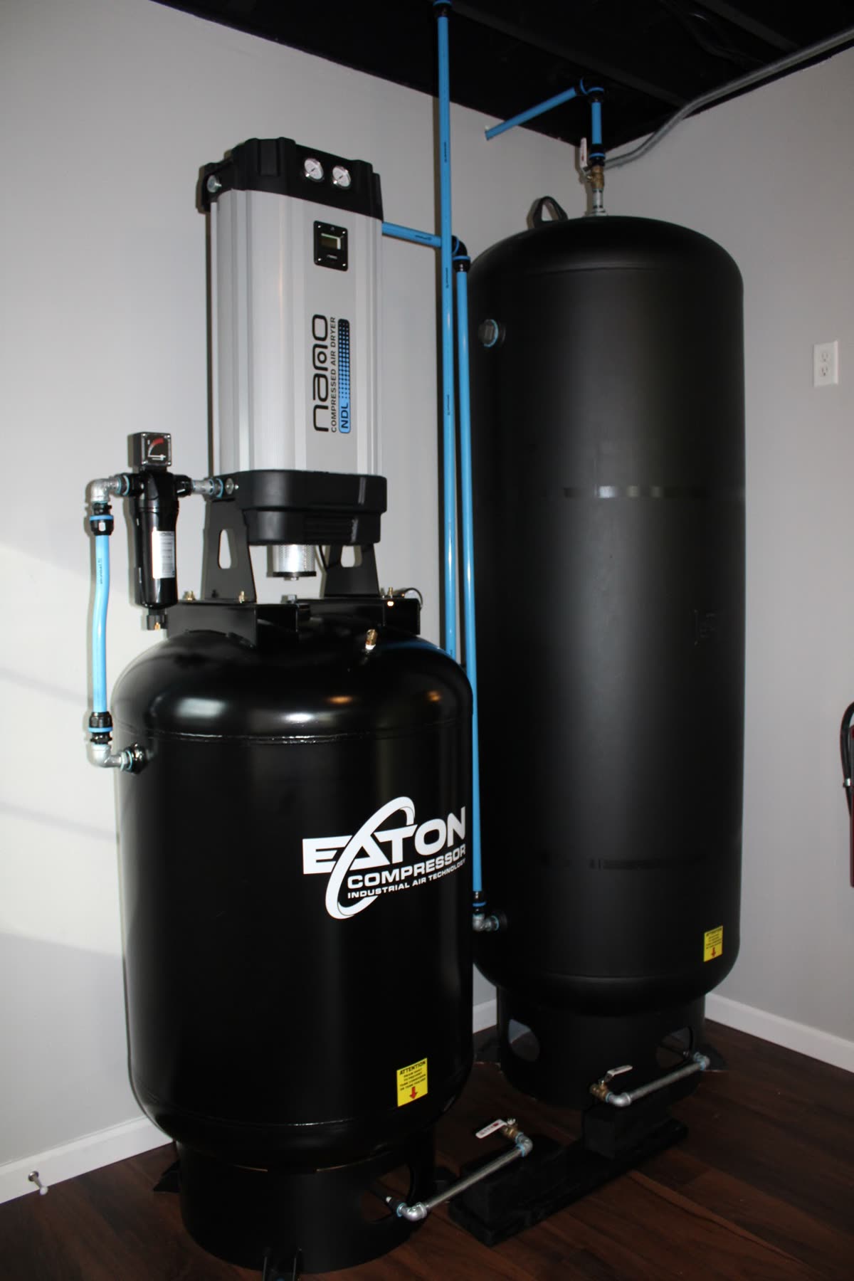 The shop's compressed air rig: an Eaton industrial compressor and a nano desiccant air dryer feeding the dry ice blaster